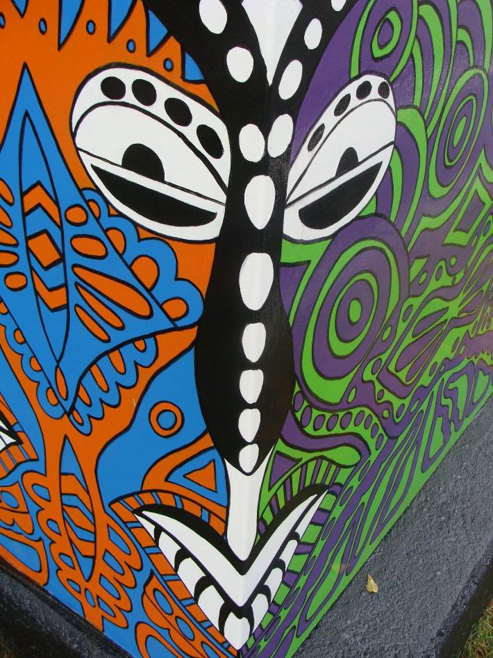 Indonesian Mask Traffic Box at Irondequoit Plaza (Titus Entrance). Part of the Silver Box Project in Irondequoit, NY which transforms traffic signal control boxes into works of art.